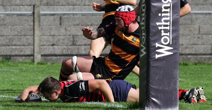 Scott James crashes over for a try for Tenby United